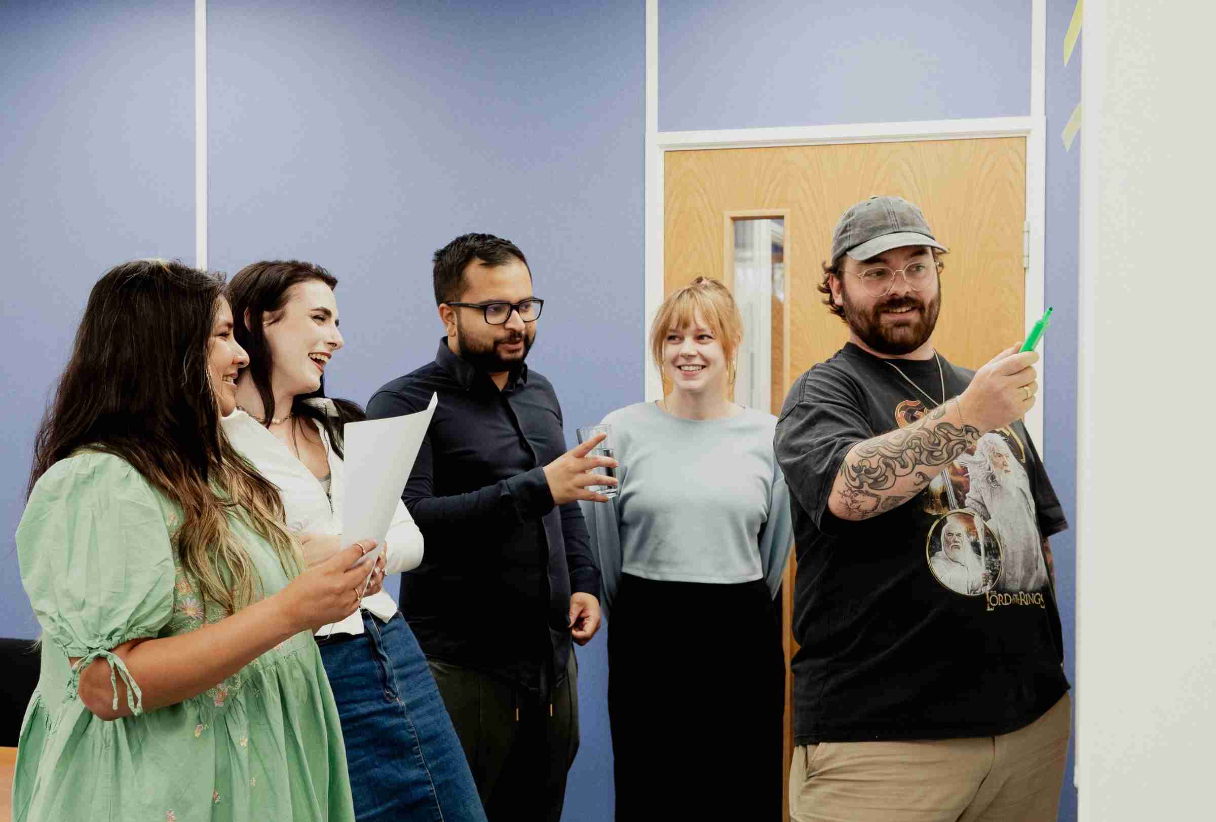 Photo Of GWCU Member Engagement Team Collaborating On Work At A White Board